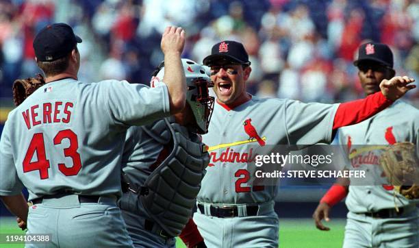 St. Louis Cardinals Dave Veres Carlos Hernandez, Will Clark and Edgar Renteria meet on the pitcher mound after beating the Atlanta Braves 7-1 to...