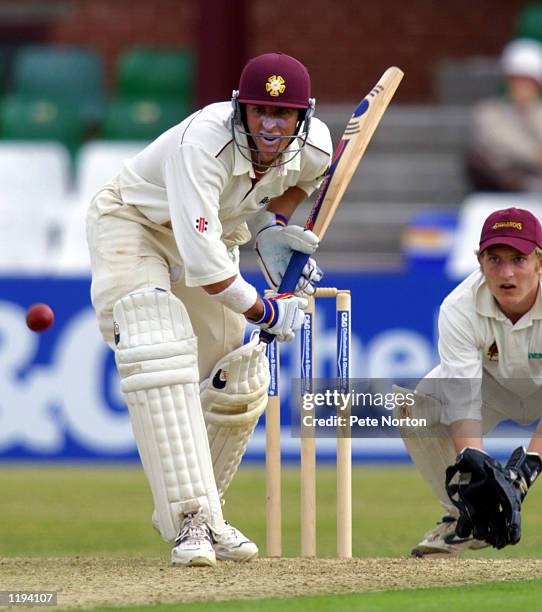 Northamptonshire's Michael Hussey is watched by Northants Board XI wicketkeeper Tom Dann during the Cheltenham & Gloucester Trophy match played...