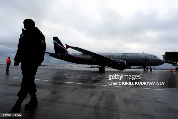 Picture shows groundstaff by an Aeroflot plane at Moscow's Sheremetyevo airport on January 17, 2020.