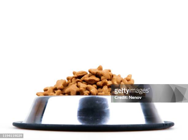 dried pet food isolated on white background - hundefutter stock-fotos und bilder