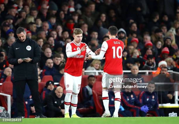 Emile Smith Rowe of Arsenal comes on for Mesut Ozil of Arsenal during the Premier League match between Arsenal FC and Manchester City at Emirates...