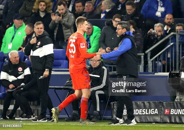 Alexander Nuebel of FC Schalke 04 embraces David Wagner, Head Coach of FC Schalke 04 as he sent off during the Bundesliga match between FC Schalke 04...