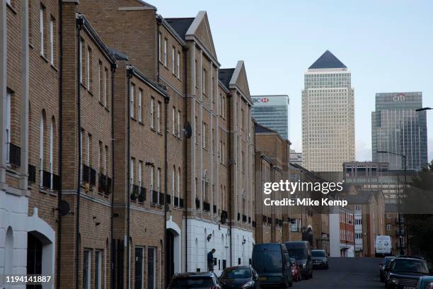 View looking along a residential street in Bermondsey towards Canary Wharf and the Docklands financial district on 5th November 2019 in London,...