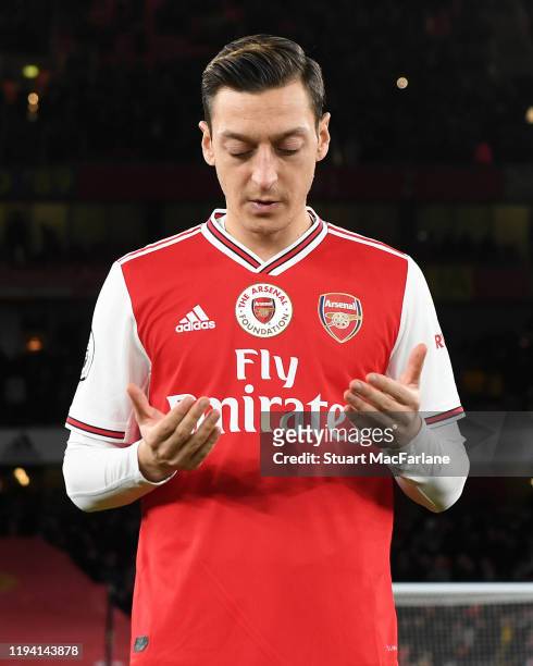 Mesut Ozil of Arsenal prays before the Premier League match between Arsenal FC and Manchester City at Emirates Stadium on December 15, 2019 in...