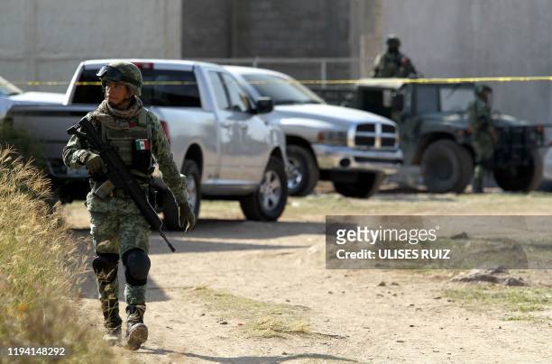 Soldiers secure the area where a clandestine mass grave was discovered at Lomas del Vergel in the community of Zapopan, Jalisco state, Mexico, on...