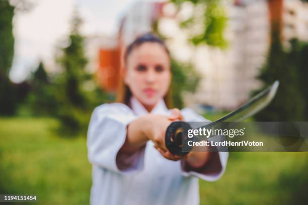 girl with samurai katana sword - samurai sword stock pictures, royalty-free photos & images