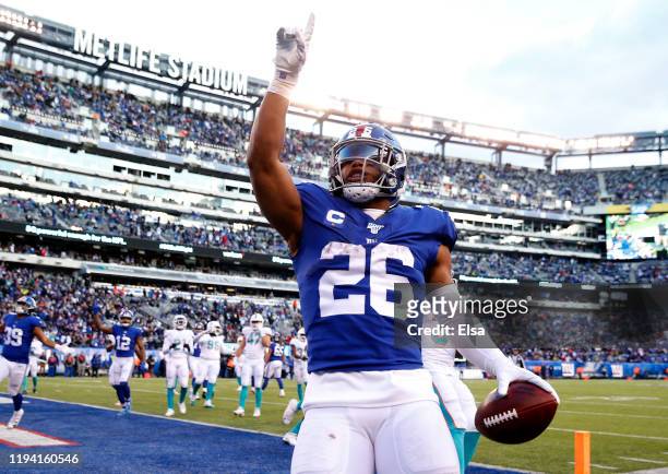 Saquon Barkley of the New York Giants celebrates his touchdown in the fourth quarter against the Miami Dolphins at MetLife Stadium on December 15,...