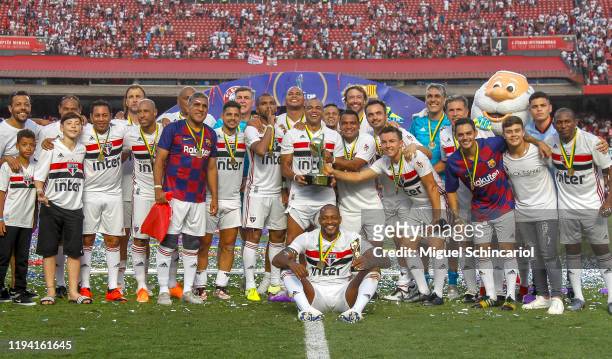 Sao Paulo FC players celebrate with their medals and the trophy after winning Legends Cup 2019 final between Sao Paulo FC and Barcelona at Morumbi...