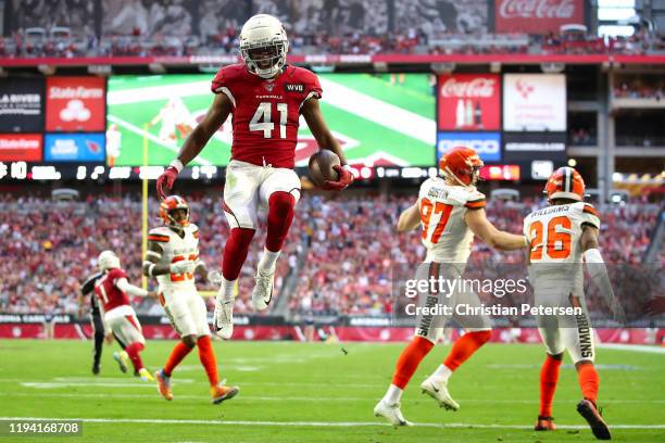 Running back Kenyan Drake of the Arizona Cardinals jumps into the end zone to score on a five yard rushing touchdown against the Cleveland Browns...