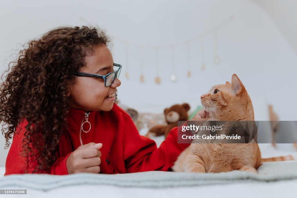Teenager playing with cat
