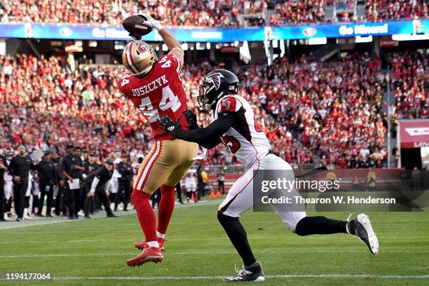 Fullback Kyle Juszczyk of the San Francisco 49ers catches a touchdown in the fourth quarter over linebacker Deion Jones of the Atlanta Falcons during...