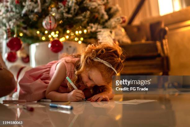 small cute girl writing letter to santa at home - answering stock pictures, royalty-free photos & images