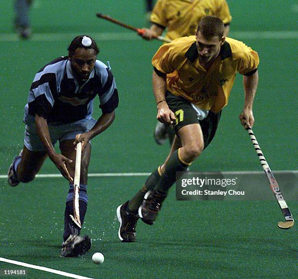 Baljit Singh Dhillon of India is pursued by Marvin Bam of South Africa during the final of the Champions Challenge Trophy Hockey Tournament held at...