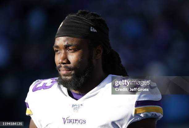 Running back Dalvin Cook of the Minnesota Vikings looks on from the bench after coming out of the game in the second half against the Los Angeles...