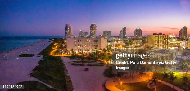 high drone view of miami in south beach, miami, florida at sunset - sunset place miami stock pictures, royalty-free photos & images