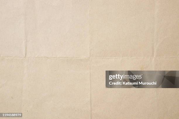 folded brown paper texture background - plegado fotografías e imágenes de stock