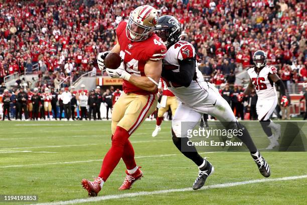 Fullback Kyle Juszczyk of the San Francisco 49ers catches a touchdown in the fourth quarter over linebacker Deion Jones of the Atlanta Falcons during...