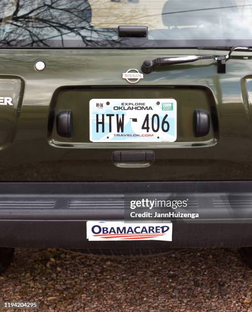 santa fe, nm: bumper sticker reading "obamacared" - bumper sticker stock pictures, royalty-free photos & images