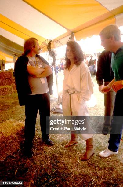 American actress Debra Winger stands, with unidentified others, backstage during the inaugural Farm Aid benefit concert at Veteran's Stadium,...