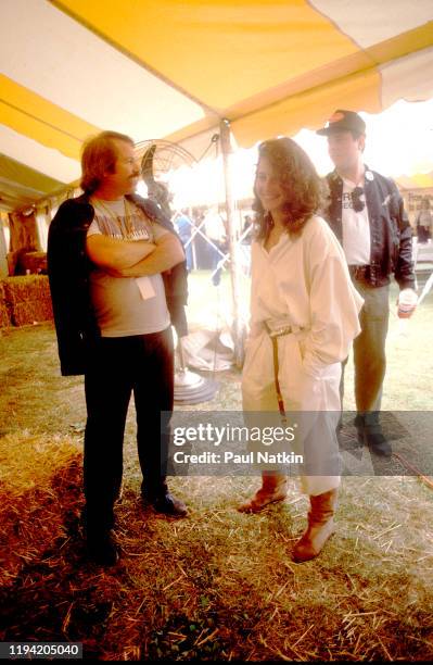 American actress Debra Winger stands, with unidentified others, backstage during the inaugural Farm Aid benefit concert at Veteran's Stadium,...
