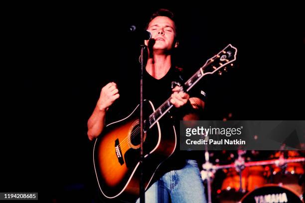 American Country musician Bryan White plays guitar as he performs onstage at Country Thunder, Twin Lakes, Wisconsin, July 15, 1998.
