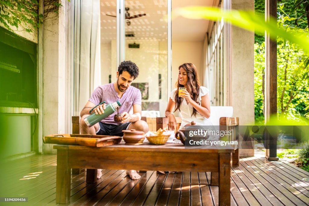 Young couple enjoying breakfast at home