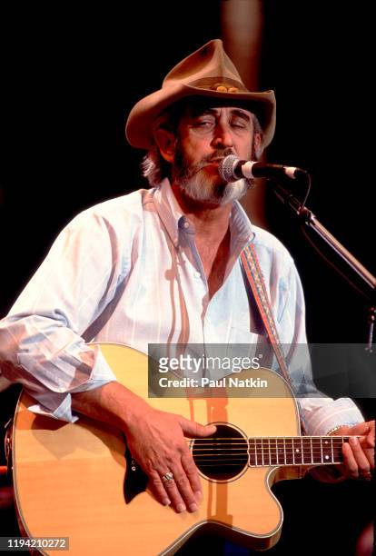 American Country musician Don Williams plays guitar as he performs onstage during the Farm Aid benefit concert, Indianapolis, Indiana, April 7, 1990.