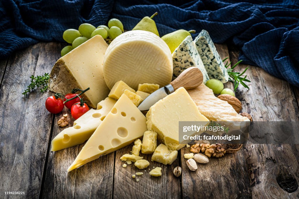 Cheeses selection on rustic wooden table