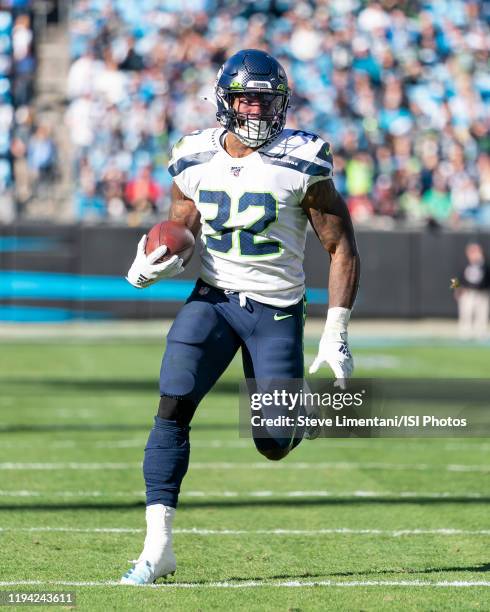 Chris Carson of the Seattle Seahawks runs with the ball during a game between Seattle Seahawks and Carolina Panthers at Bank of America Stadium on...