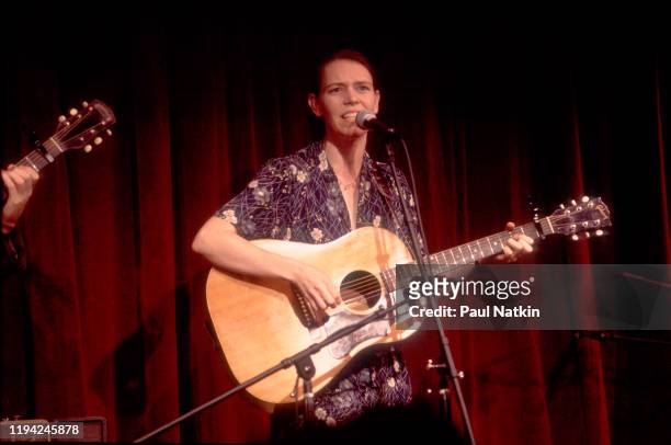 American Country and Folk musician Gillian Welch plays guitar as she performs onstage at the Old Town School of Folk Music, Chicago, Illinois,...