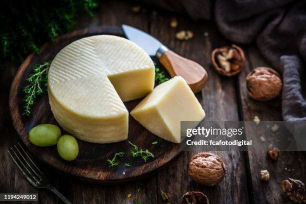 goat cheese on rustic wooden table - french soft cheese stock pictures, royalty-free photos & images
