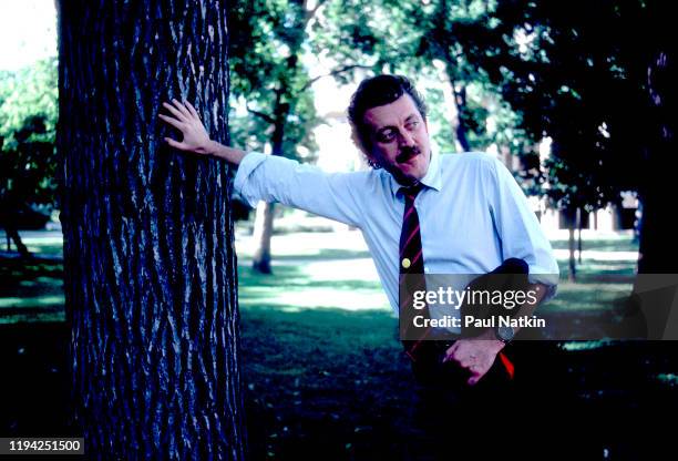 Portrait of Swiss Pop and Electronic musician Dieter Meier, of the group Yello, as he leans against a tree on the campus of Northwestern University,...