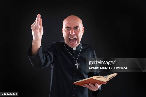screaming priest in sermon holding bible hand angry - pastor stock pictures, royalty-free photos & images
