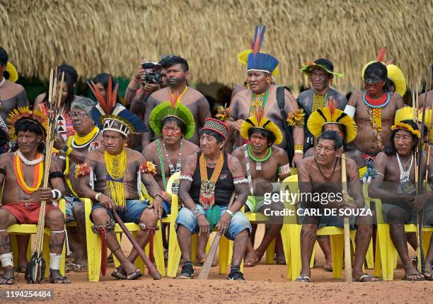 Members from different Brazilian tribes listen to their leader Cacique Raoni Metuktire of the Kayapo tribe, in Piaracu village, near Sao Jose do...