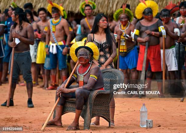 Indigenous leader Cacique Raoni Metuktire of the Kayapo tribe, watches as various tribes perform ceremonial dances for him, in Piaracu village, near...