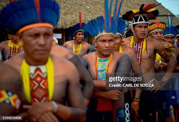 Members of the Tapirape tribe wait to perform a ceremonial dance for their leader Cacique Raoni Metuktire of the Kayapo tribe, in Piaracu village,...