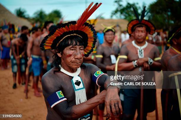 Members of the Kisejde tribe wait to perform a ceremonial dance for their leader Cacique Raoni Metuktire of the Kayapo tribe, in Piaracu village,...