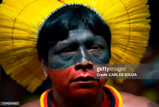 Member of the Kayapo tribe listens to his leader Cacique Raoni Metuktire of the Kayapo tribe, in Piaracu village, near Sao Jose do Xingu, Mato Grosso...