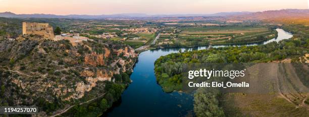 aerial view of the village of miravet at the ebro river in tarragona at sunset, catalonia. spain - ebro river stock pictures, royalty-free photos & images