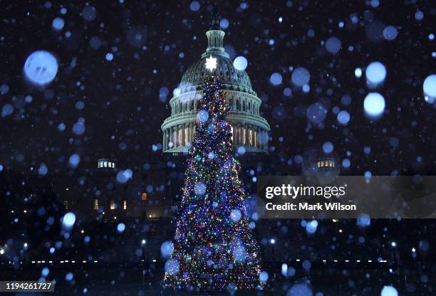 Wintry mix of sleet and snow falls on the U.S. Capitol and its Christmas Tree on December 16, 2019 in Washington, DC. Later this week the full House...