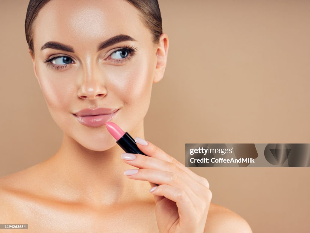 Beautiful girl applying make-up