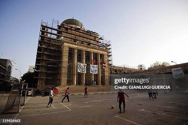 Libyan youth play football outside the Benghazi Cathedral on June 5 in the Libyan rebels' stronghold city of Benghazi. Benghazi cathedral, designed...