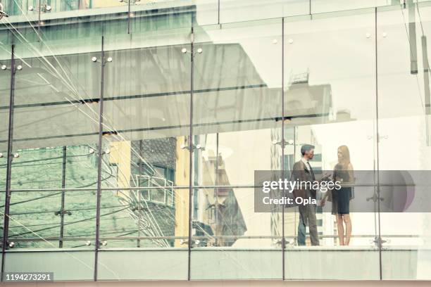 two business people on elevated wlakway - commercial property imagens e fotografias de stock