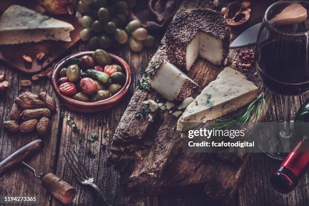 cheese and wine on rustic wooden table. vintage processing - roquefort cheese stock pictures, royalty-free photos & images