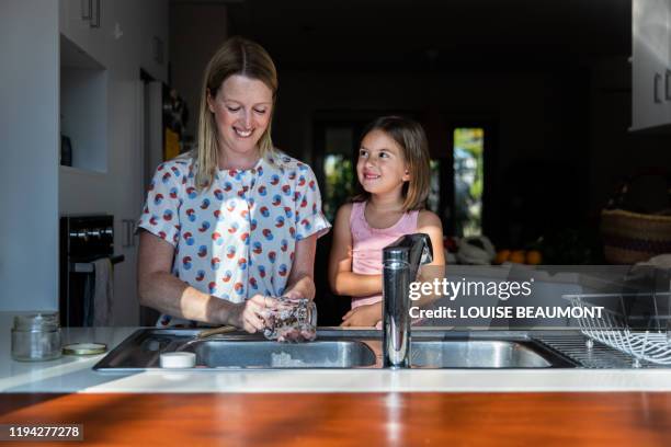 doing the dishes with mum - water conservation stock pictures, royalty-free photos & images