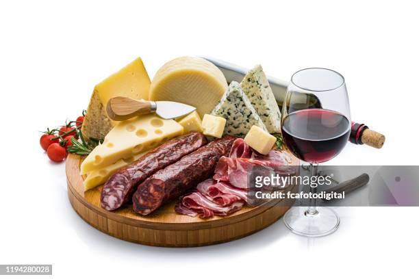 cheese and wine: cheese, chorizo, serrono ham and red wine isolated on white background - cheese board imagens e fotografias de stock