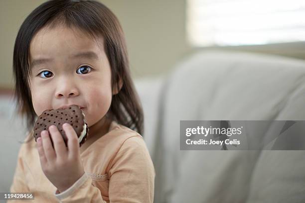 Asian Girl Eating An Ice Cream Sandwich High-Res Stock Photo