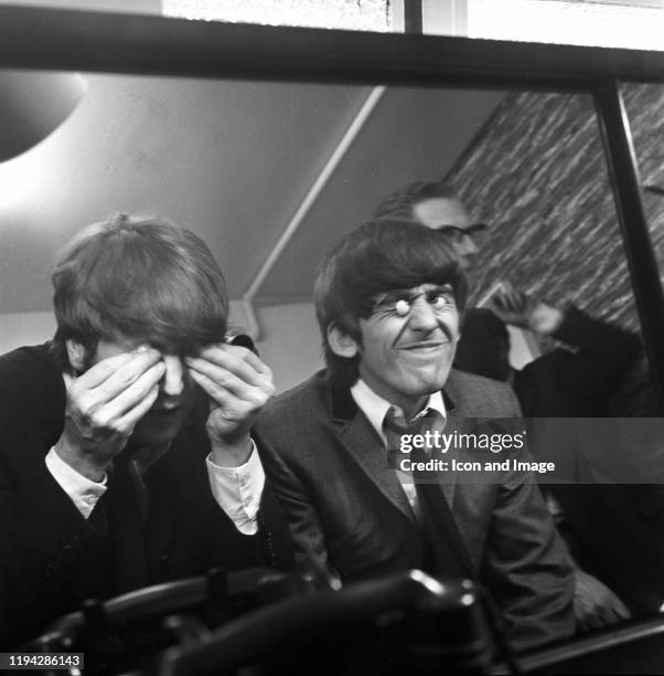 English singer, songwriter and musician John Lennon and English singer, songwriter and lead guitarist George Harrison , both of the Beatles, at...