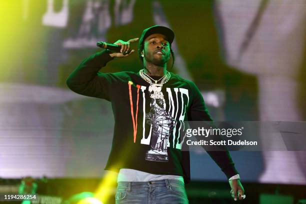 Rapper Pop Smoke performs onstage during day 2 of the Rolling Loud Festival at Banc of California Stadium on December 15, 2019 in Los Angeles,...