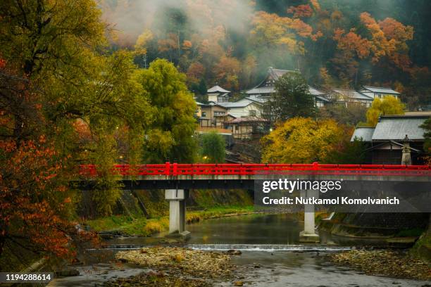 takayama red old and historical bridge in the morning of autumn - gifu prefecture stock pictures, royalty-free photos & images